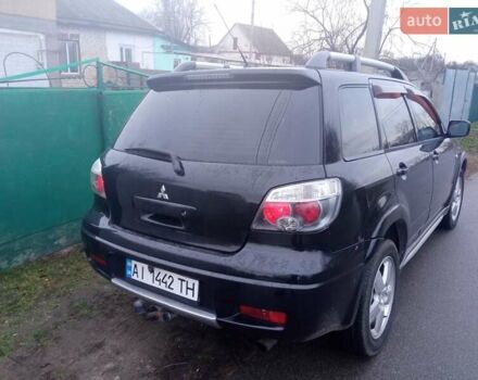 Черный Мицубиси Аутлендер, объемом двигателя 2 л и пробегом 220 тыс. км за 5599 $, фото 1 на Automoto.ua