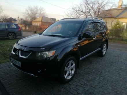 Черный Мицубиси Аутлендер, объемом двигателя 2.4 л и пробегом 228 тыс. км за 7850 $, фото 1 на Automoto.ua