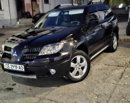 Черный Мицубиси Аутлендер, объемом двигателя 2 л и пробегом 117 тыс. км за 7900 $, фото 1 на Automoto.ua