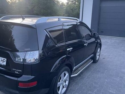 Черный Мицубиси Аутлендер, объемом двигателя 2.4 л и пробегом 290 тыс. км за 9500 $, фото 1 на Automoto.ua