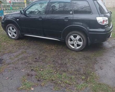 Черный Мицубиси Аутлендер, объемом двигателя 2.4 л и пробегом 270 тыс. км за 6700 $, фото 1 на Automoto.ua