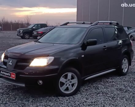 Черный Мицубиси Аутлендер, объемом двигателя 2 л и пробегом 271 тыс. км за 6940 $, фото 1 на Automoto.ua