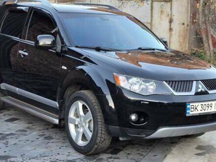 Черный Мицубиси Аутлендер, объемом двигателя 2.4 л и пробегом 230 тыс. км за 9700 $, фото 1 на Automoto.ua