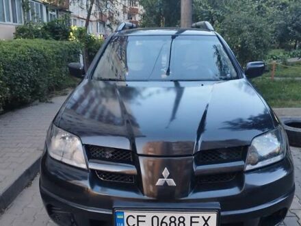 Черный Мицубиси Аутлендер, объемом двигателя 2 л и пробегом 245 тыс. км за 5500 $, фото 1 на Automoto.ua