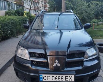 Черный Мицубиси Аутлендер, объемом двигателя 2 л и пробегом 245 тыс. км за 5500 $, фото 1 на Automoto.ua