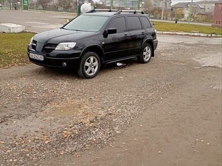 Черный Мицубиси Аутлендер, объемом двигателя 2 л и пробегом 209 тыс. км за 5700 $, фото 1 на Automoto.ua