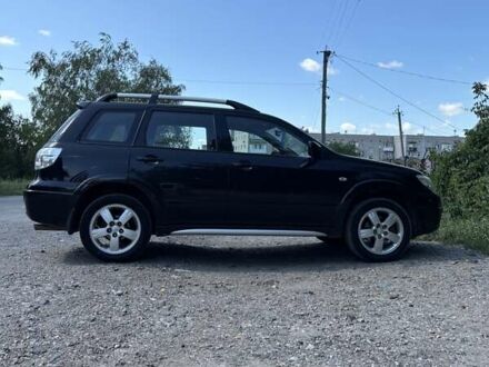 Черный Мицубиси Аутлендер, объемом двигателя 2.38 л и пробегом 146 тыс. км за 7500 $, фото 1 на Automoto.ua