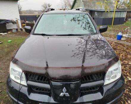Черный Мицубиси Аутлендер, объемом двигателя 2.4 л и пробегом 149 тыс. км за 8800 $, фото 1 на Automoto.ua