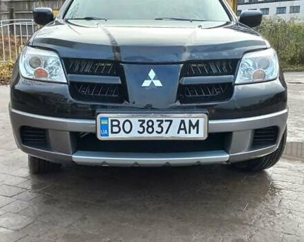 Черный Мицубиси Аутлендер, объемом двигателя 2 л и пробегом 73 тыс. км за 9500 $, фото 1 на Automoto.ua