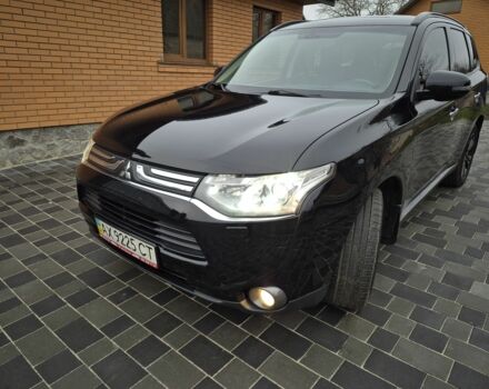 Черный Мицубиси Аутлендер, объемом двигателя 2.4 л и пробегом 211 тыс. км за 12590 $, фото 1 на Automoto.ua