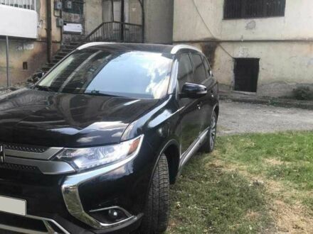 Черный Мицубиси Аутлендер, объемом двигателя 2.4 л и пробегом 125 тыс. км за 11200 $, фото 1 на Automoto.ua