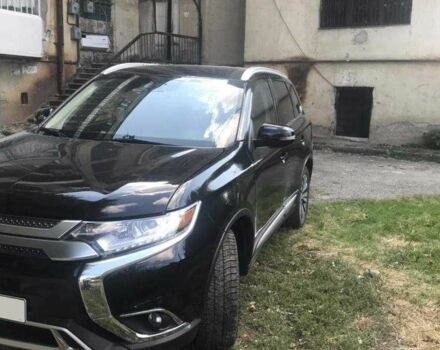 Черный Мицубиси Аутлендер, объемом двигателя 2.4 л и пробегом 125 тыс. км за 11200 $, фото 1 на Automoto.ua