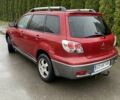 Красный Мицубиси Аутлендер, объемом двигателя 2.4 л и пробегом 293 тыс. км за 3595 $, фото 1 на Automoto.ua