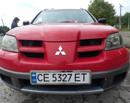 Красный Мицубиси Аутлендер, объемом двигателя 2 л и пробегом 217 тыс. км за 6250 $, фото 1 на Automoto.ua