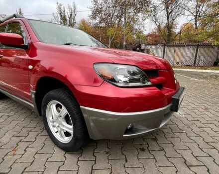 Красный Мицубиси Аутлендер, объемом двигателя 2.4 л и пробегом 174 тыс. км за 6900 $, фото 1 на Automoto.ua