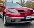 Красный Мицубиси Аутлендер, объемом двигателя 2.4 л и пробегом 174 тыс. км за 6900 $, фото 1 на Automoto.ua