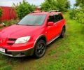Красный Мицубиси Аутлендер, объемом двигателя 2.4 л и пробегом 320 тыс. км за 4800 $, фото 1 на Automoto.ua