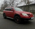 Красный Мицубиси Аутлендер, объемом двигателя 2.4 л и пробегом 224 тыс. км за 5600 $, фото 1 на Automoto.ua