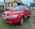 Красный Мицубиси Аутлендер, объемом двигателя 2 л и пробегом 290 тыс. км за 4700 $, фото 1 на Automoto.ua
