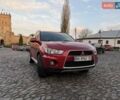 Красный Мицубиси Аутлендер, объемом двигателя 2.36 л и пробегом 134 тыс. км за 10600 $, фото 1 на Automoto.ua