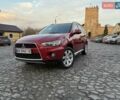 Красный Мицубиси Аутлендер, объемом двигателя 2.36 л и пробегом 134 тыс. км за 10600 $, фото 1 на Automoto.ua