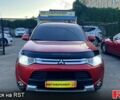 Красный Мицубиси Аутлендер, объемом двигателя 2.4 л и пробегом 209 тыс. км за 12990 $, фото 1 на Automoto.ua
