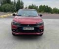 Красный Мицубиси Аутлендер, объемом двигателя 2 л и пробегом 124 тыс. км за 11900 $, фото 1 на Automoto.ua