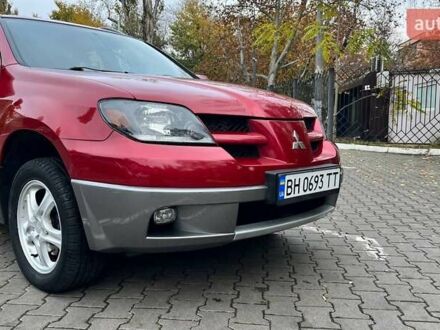Красный Мицубиси Аутлендер, объемом двигателя 2.4 л и пробегом 174 тыс. км за 6900 $, фото 1 на Automoto.ua