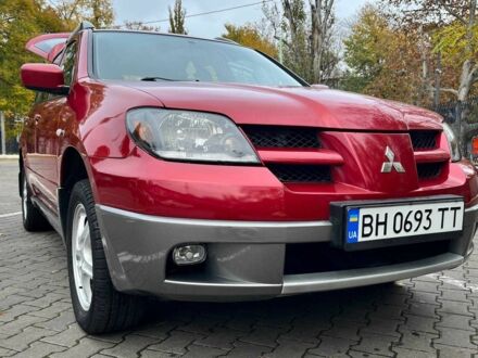 Красный Мицубиси Аутлендер, объемом двигателя 2.4 л и пробегом 174 тыс. км за 6900 $, фото 1 на Automoto.ua