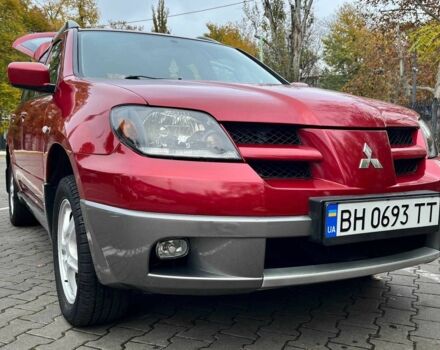 Красный Мицубиси Аутлендер, объемом двигателя 2.4 л и пробегом 174 тыс. км за 6900 $, фото 1 на Automoto.ua