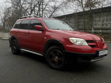 Красный Мицубиси Аутлендер, объемом двигателя 2.4 л и пробегом 224 тыс. км за 5600 $, фото 1 на Automoto.ua