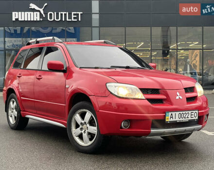 Красный Мицубиси Аутлендер, объемом двигателя 2.4 л и пробегом 308 тыс. км за 5990 $, фото 1 на Automoto.ua