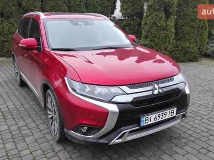 Красный Мицубиси Аутлендер, объемом двигателя 3 л и пробегом 127 тыс. км за 28500 $, фото 1 на Automoto.ua