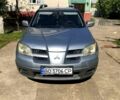 Серый Мицубиси Аутлендер, объемом двигателя 2 л и пробегом 228 тыс. км за 4900 $, фото 1 на Automoto.ua