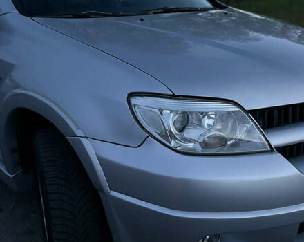 Серый Мицубиси Аутлендер, объемом двигателя 2.38 л и пробегом 238 тыс. км за 7450 $, фото 1 на Automoto.ua