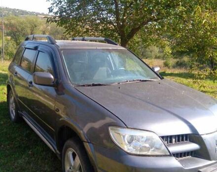 Серый Мицубиси Аутлендер, объемом двигателя 2.38 л и пробегом 117 тыс. км за 7900 $, фото 1 на Automoto.ua