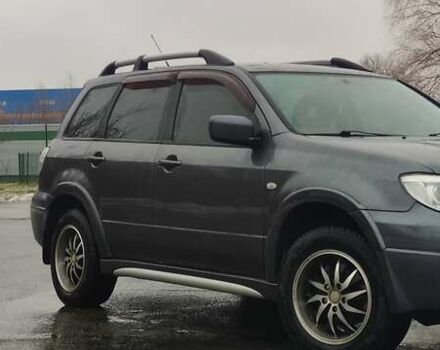 Серый Мицубиси Аутлендер, объемом двигателя 2 л и пробегом 200 тыс. км за 5999 $, фото 1 на Automoto.ua