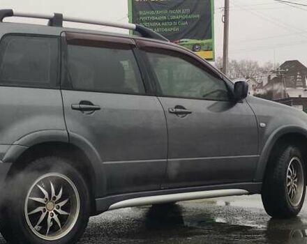 Серый Мицубиси Аутлендер, объемом двигателя 2 л и пробегом 200 тыс. км за 5999 $, фото 4 на Automoto.ua