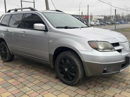 Серый Мицубиси Аутлендер, объемом двигателя 2.4 л и пробегом 256 тыс. км за 6700 $, фото 1 на Automoto.ua