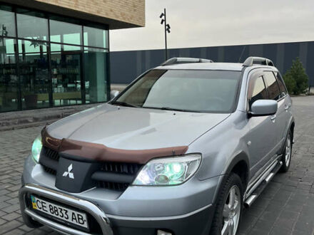 Серый Мицубиси Аутлендер, объемом двигателя 2.38 л и пробегом 180 тыс. км за 6000 $, фото 1 на Automoto.ua