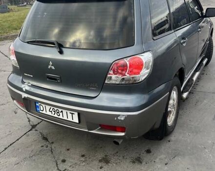 Синий Мицубиси Аутлендер, объемом двигателя 2.38 л и пробегом 300 тыс. км за 4200 $, фото 2 на Automoto.ua