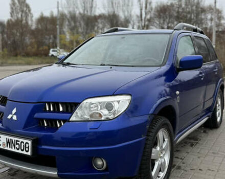 Синий Мицубиси Аутлендер, объемом двигателя 2.4 л и пробегом 243 тыс. км за 5000 $, фото 1 на Automoto.ua
