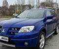 Синий Мицубиси Аутлендер, объемом двигателя 2.4 л и пробегом 243 тыс. км за 5000 $, фото 1 на Automoto.ua