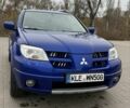 Синий Мицубиси Аутлендер, объемом двигателя 2.4 л и пробегом 243 тыс. км за 5000 $, фото 1 на Automoto.ua
