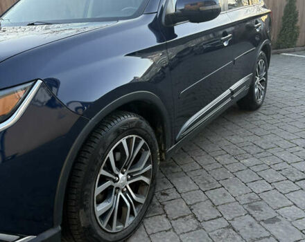 Синий Мицубиси Аутлендер, объемом двигателя 2.38 л и пробегом 99 тыс. км за 15400 $, фото 1 на Automoto.ua