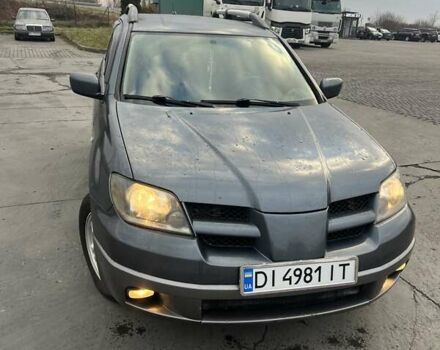 Синий Мицубиси Аутлендер, объемом двигателя 2.38 л и пробегом 300 тыс. км за 4200 $, фото 1 на Automoto.ua