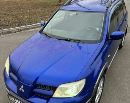 Синий Мицубиси Аутлендер, объемом двигателя 2.4 л и пробегом 300 тыс. км за 4000 $, фото 1 на Automoto.ua