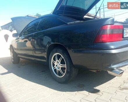 Черный Опель Калибра, объемом двигателя 2 л и пробегом 256 тыс. км за 3000 $, фото 1 на Automoto.ua