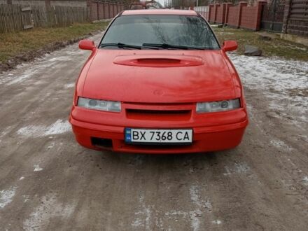 Красный Опель Калибра, объемом двигателя 2 л и пробегом 120 тыс. км за 1399 $, фото 1 на Automoto.ua