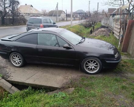 Серый Опель Калибра, объемом двигателя 2 л и пробегом 338 тыс. км за 2840 $, фото 1 на Automoto.ua